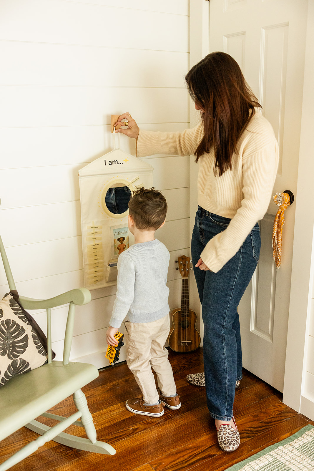 Mom and son hanging the Magic Mirror affirmation chart together